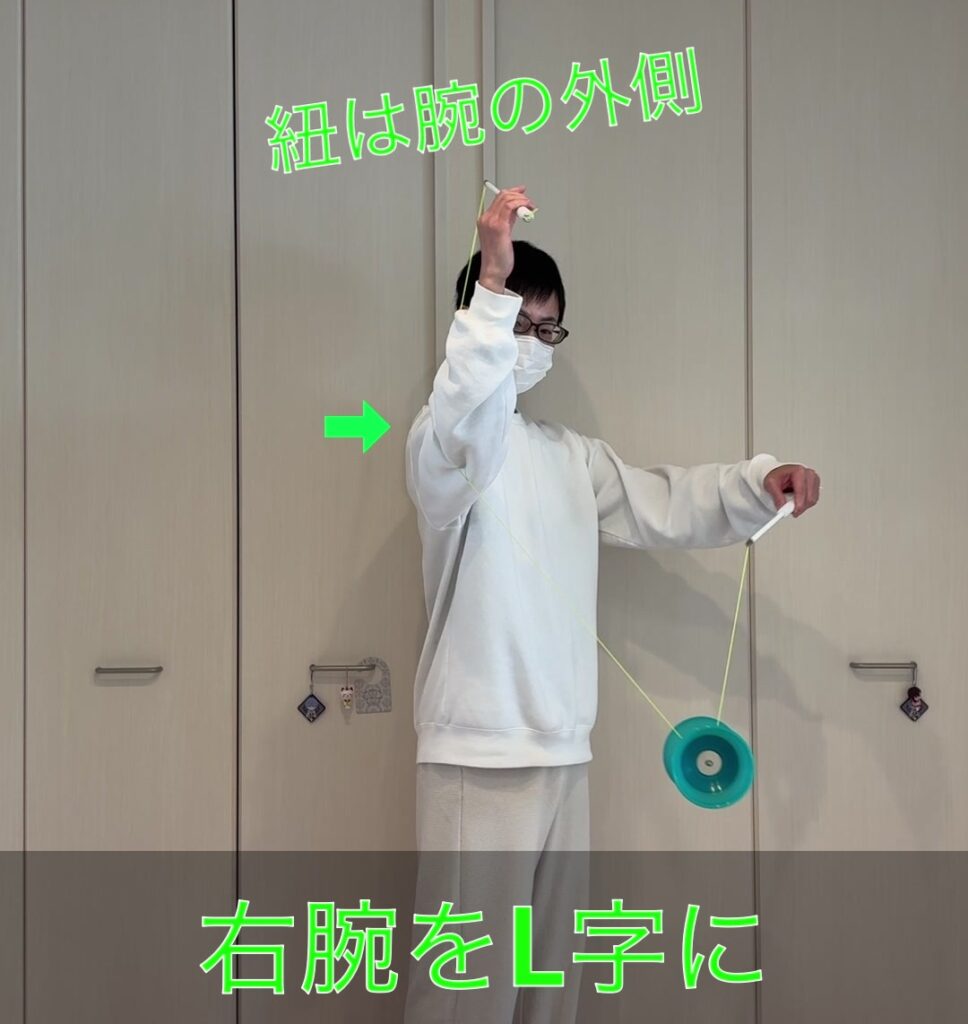 右腕をL字に構えた際に紐が腕の外側を通っている正しいポジションの画像